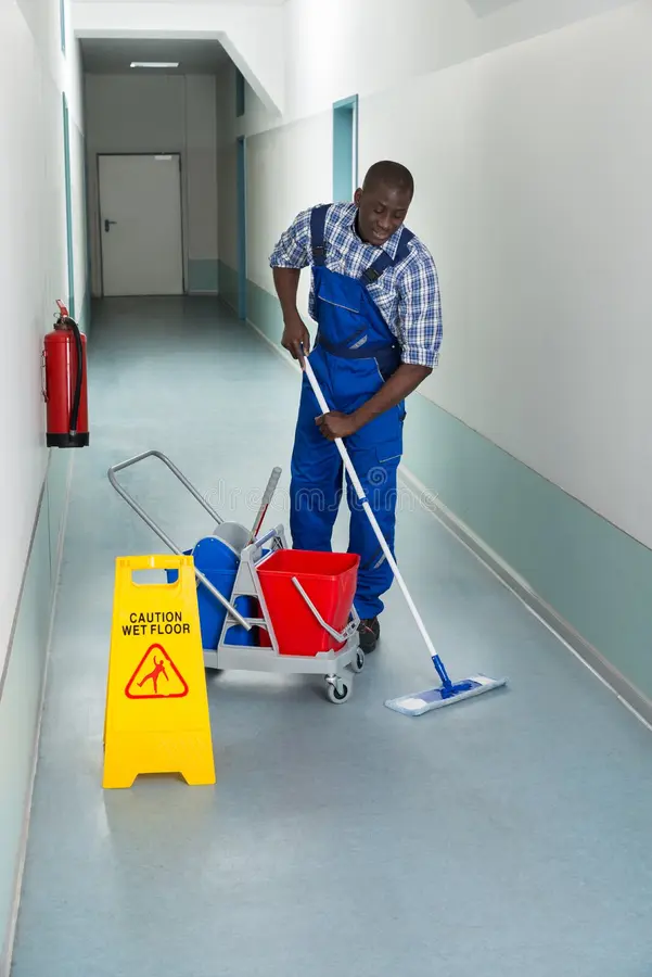 Home male janitor cleaning floor portrait young african corridor 57190768